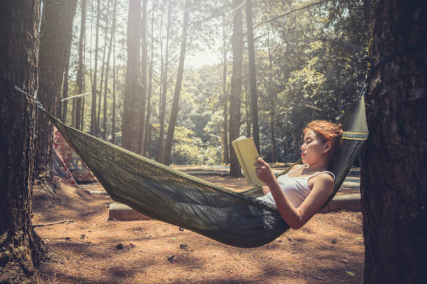 istock Sleeping women write notes. In the hammock. In the natural atmosphere in the park 891413068
