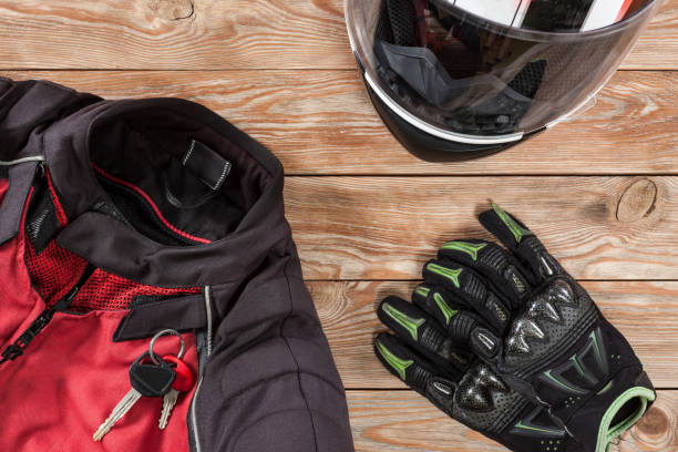 istock View of motorcycle rider accessories placed on rustic wooden table. 891415798