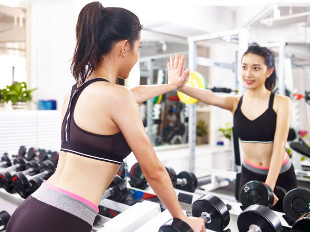 istock young asian woman exercising in gym 891416084