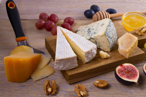 istock Cheese selection on wooden rustic background. Cheese platter with different cheeses 891416112