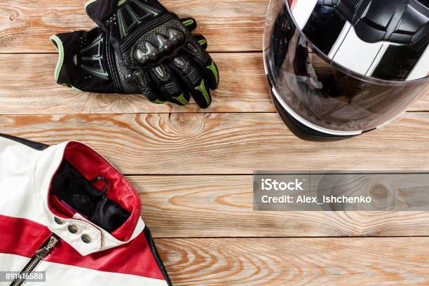 View Of Motorcycle Rider Accessories Placed On Rustic Wooden Table Stock Photo - Download Image Now