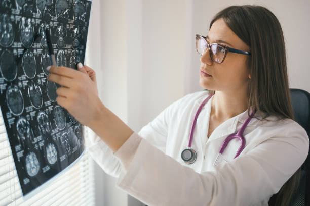 istock Young female doctor looking at x-ray scan 891418794