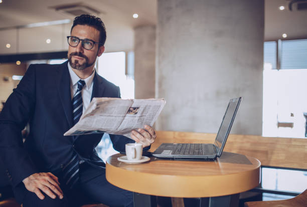 istock Gentleman reading newspaper 891419380