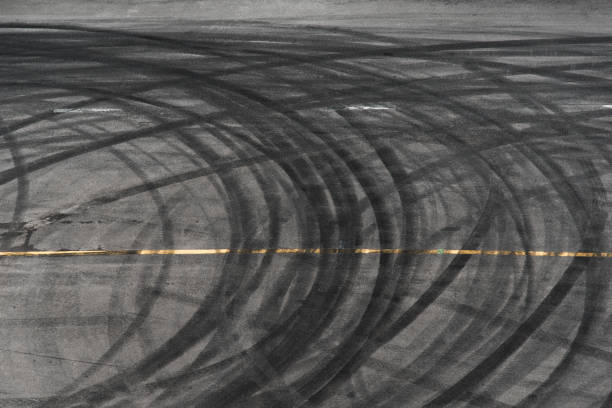 abstract of black tire wheels caused by drift car on the road - road top view imagens e fotografias de stock