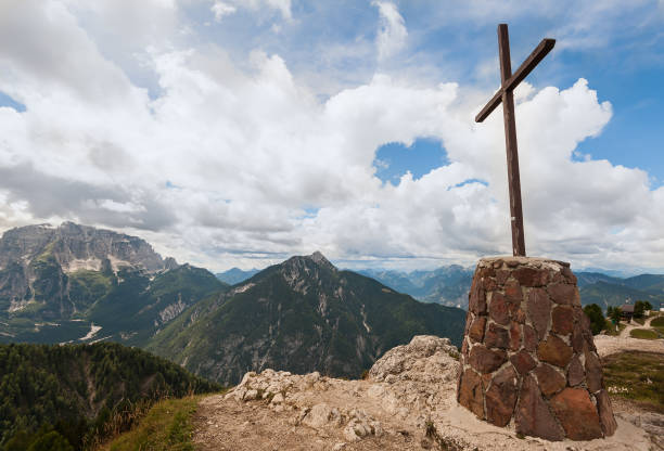 istock Mountain landscape with cross ,blue sky and clouds. 891422594