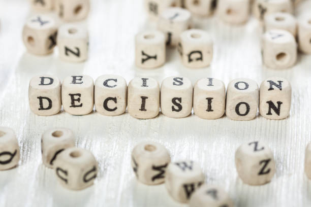 istock Decision word written on wood block. 891428738