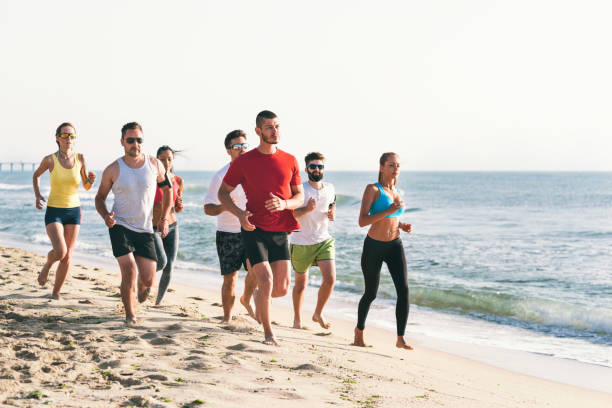 istock Young people exercising on the coastline. 891428916