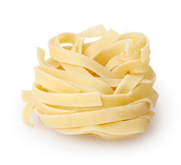 istock Uncooked nest of tagliatelle pasta isolated on white background with clipping path 891429306