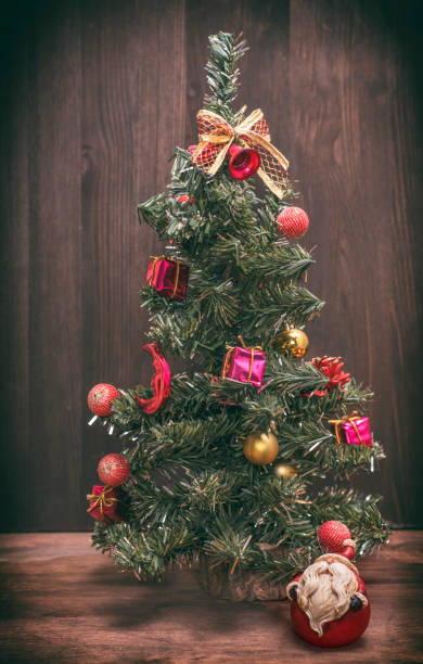 istock christmas tree on a wooden background 891429628