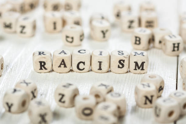 istock Racism word written on wood block. 891430002