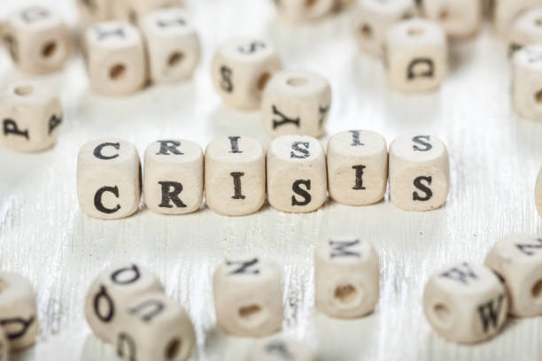 istock Crisis word written on wood block. 891430392