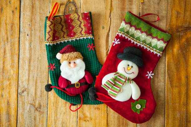 istock Christmas decoration stocking and snow flake hanging over rustic wooden background 891432872