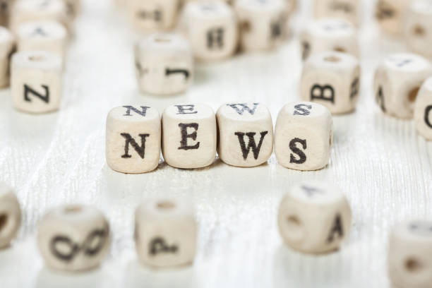 istock News word written on wood block. 891433074