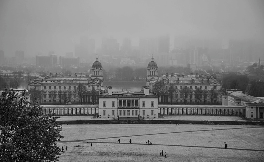 Greenwich Park in the snow with the Isle of Dogs silhouetted in the distance.