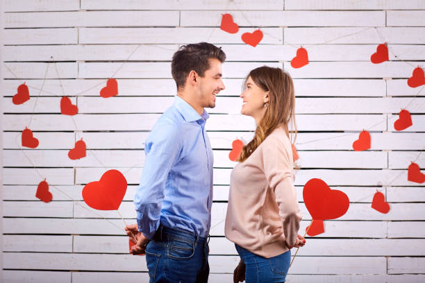 istock Man and woman with hearts on a white board background. 891437688