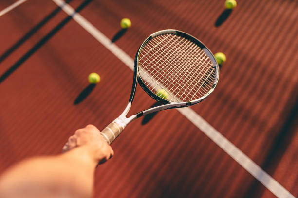 istock Balls and racket on tennis court. 891437712