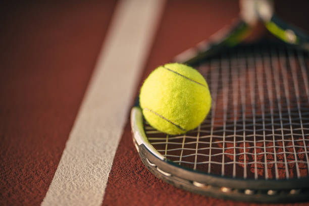 istock Balls and racket on tennis court. 891437768