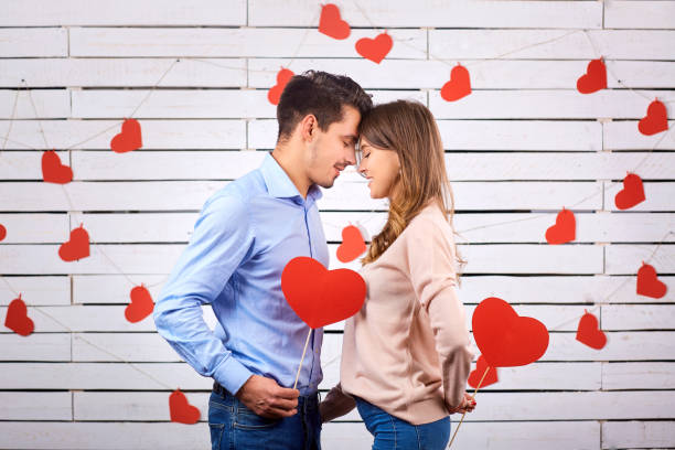 istock Man and woman with hearts on a white board background. 891437826