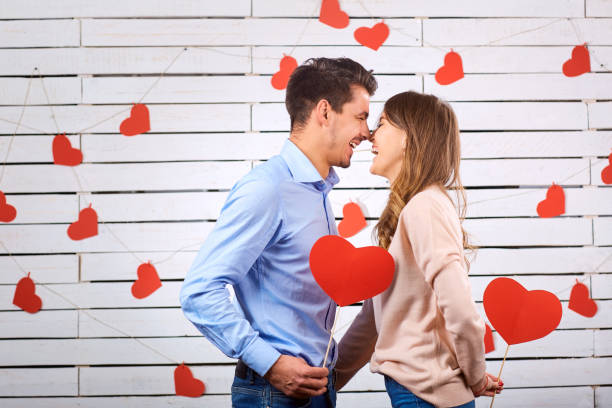istock Man and woman with hearts on a white board background. 891437864