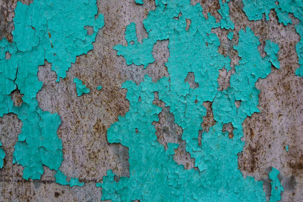 istock Blue cracked painting on old plaster wall surface 891441100