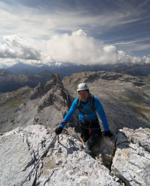 istock male climber summits a peak in the DOlomites on a Via Ferrata 891441470