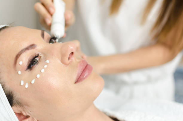 istock Cosmetologist during anti age treatment on patient face 891441632