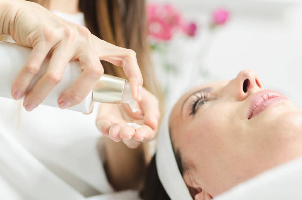 istock Final procedure for woman face in beauty spa salon 891441672