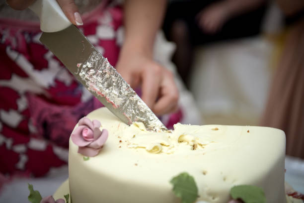 istock Bride and groom cut their wedding cake 891441728