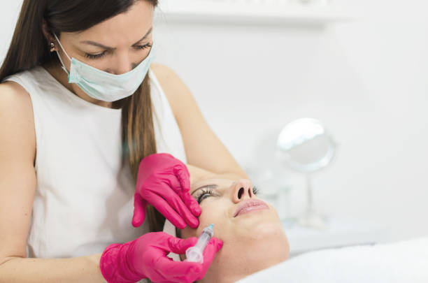 istock Woman getting botox injection in face 891441752