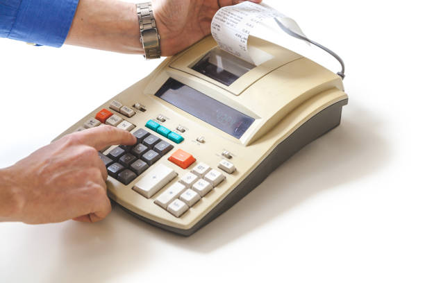 istock Hand presses cash register keys another takes out check 891441844