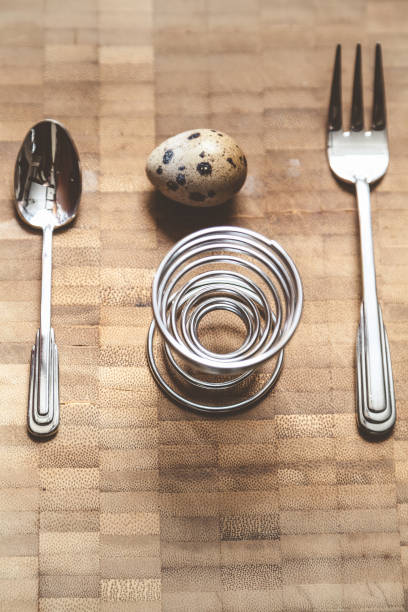 Egg quail, helical rack and equipment on board Egg quail, spiral stand, fork, spoon lie on the board. Set for dietary breakfast helical stock pictures, royalty-free photos & images