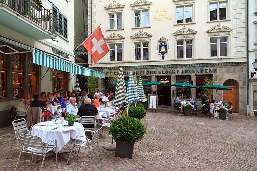 Paris, France – May 27, 2022: An aerial view of sidewalk cafe with table and chairs in Paris