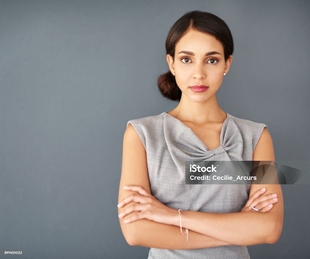 I don’t do doubt, only determination Studio portrait of an attractive young businesswoman posing against a gray background Serious Stock Photo