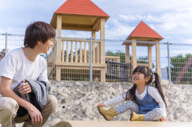istock Father and girl playing in the park 891451538