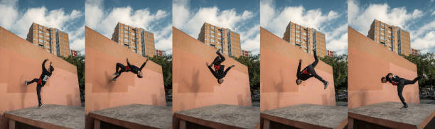 Man jumping and doing backflips while practicing parkour in the city Man jumping and doing backflips while practicing parkour in the city parkour sequence stock pictures, royalty-free photos & images