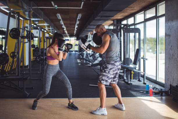 istock Woman doing kickboxing workout with her coach. 891455602