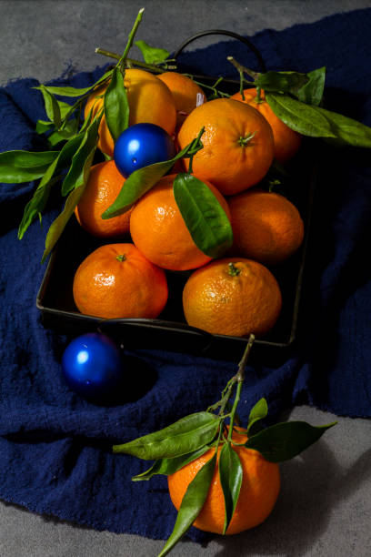 istock Tangerines, clementines with leaves. Dark,gray background. 891456246