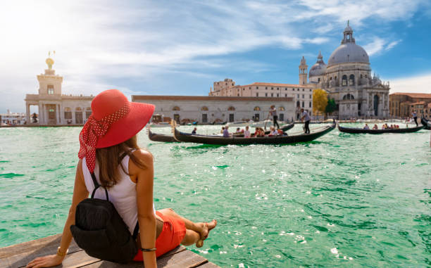Female tourist looking the Basilica di Santa Maria della Salute and Canale Grande in Venice, Italy Attractive, female tourist enjoys the view to the Basilica di Santa Maria della Salute and Canale Grande in Venice, Italy church ladies stock pictures, royalty-free photos & images
