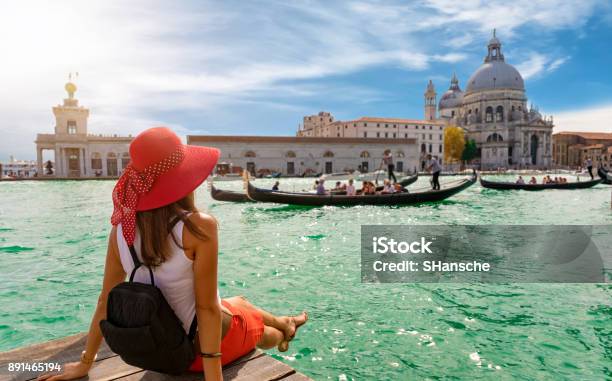 Female Tourist Looking The Basilica Di Santa Maria Della Salute And Canale Grande In Venice Italy Stock Photo - Download Image Now