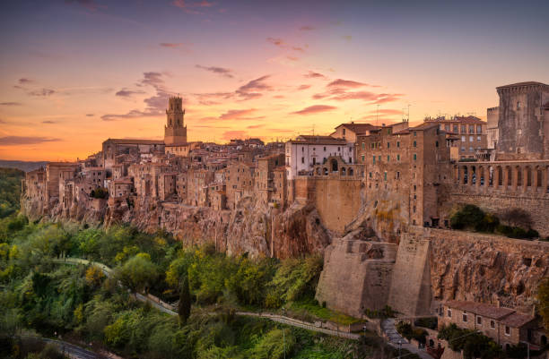 Tuscany, Pitigliano medieval village panorama sunset. Italy Tuscany, Pitigliano medieval village on tuff rocky hill. Panorama sunset. Italy, Europe. siena italy stock pictures, royalty-free photos & images