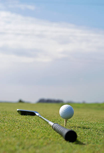 istock Golf ball in tall green grass set against blue sky 89147833