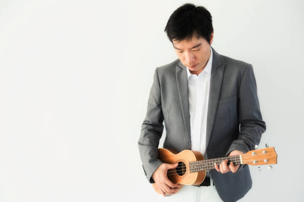 istock Handsome artist man play ukulele 891484092