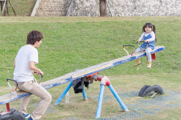 istock Father and girl playing in the park 891484206