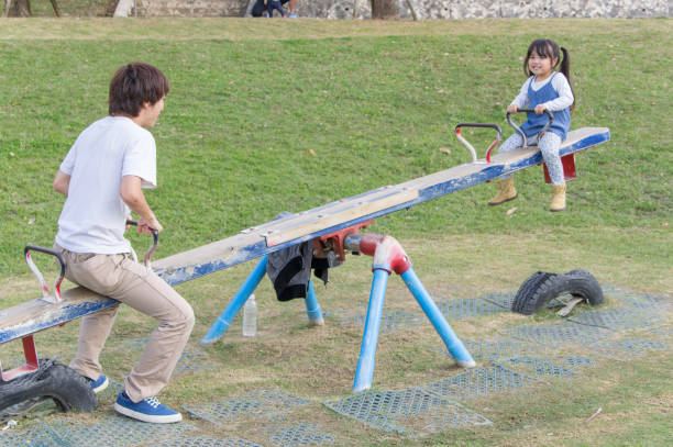 istock Father and girl playing in the park 891484292