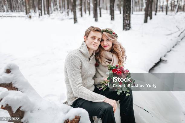 Beautiful Bride And Groom Posing On Background Of Snowy Forest Artwork Stock Photo - Download Image Now