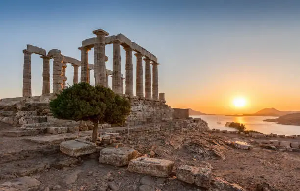 The ancient Temple of Poseidon during a summer sunset at Sounion, Attica, Greece