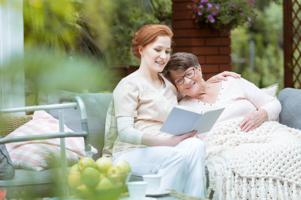 istock Young assistant hugs elder woman 891500660