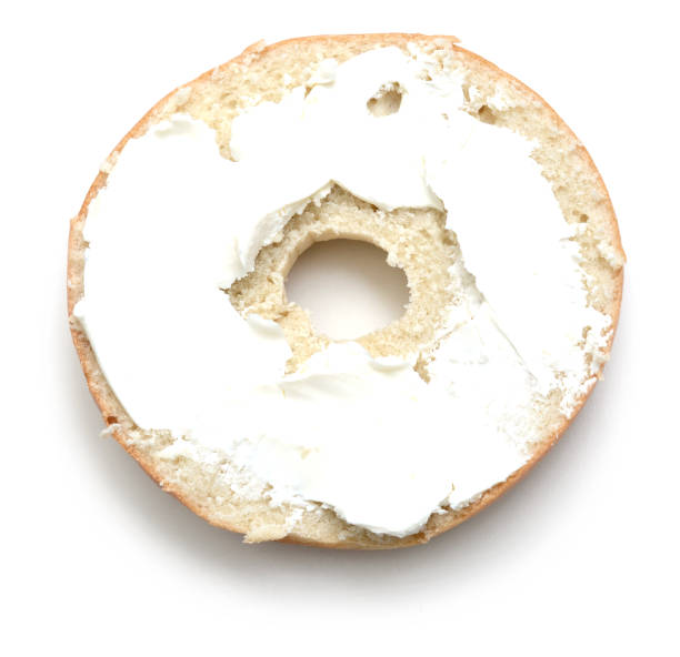 istock Plain bagel cut in half and spread with cream cheese 891500944