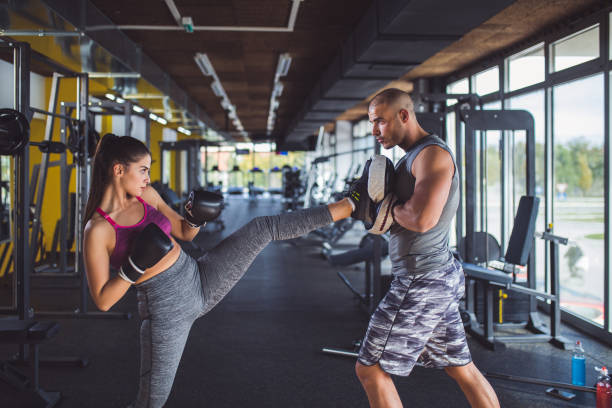 istock Woman doing kickboxing workout with her coach. 891500966