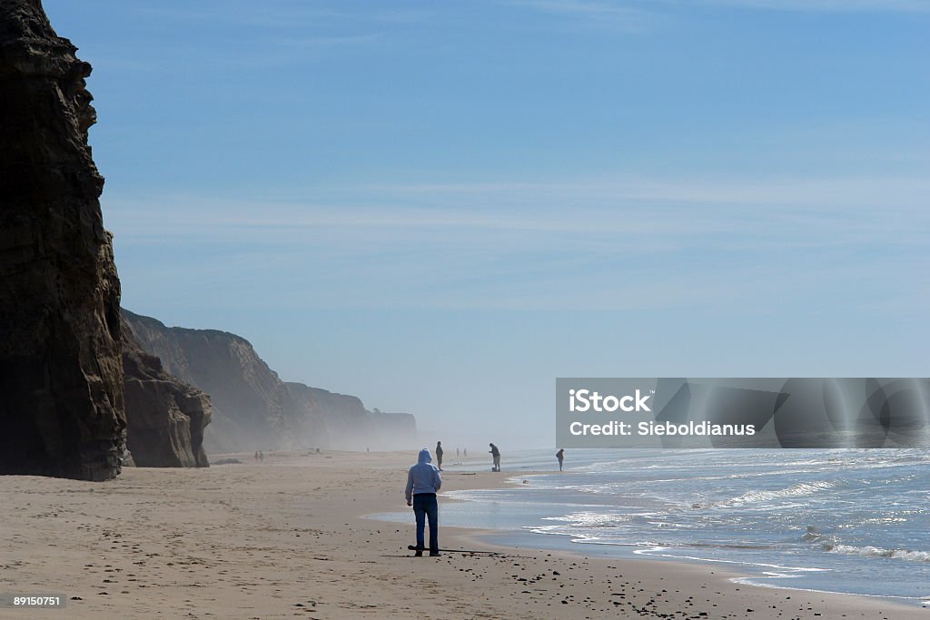 Beach with people relaxing.  Distant Stock Photo